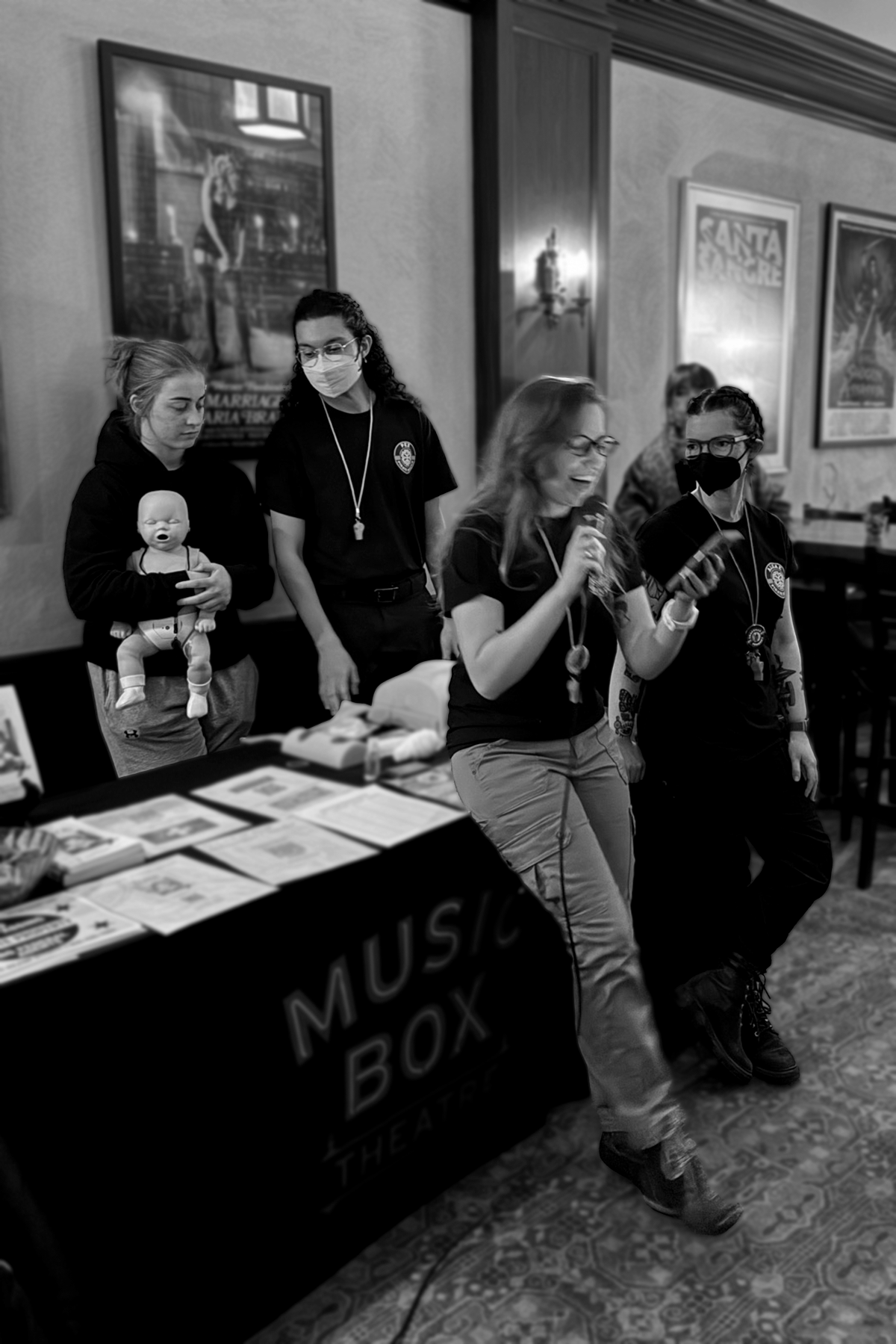A black and white candid photo showing several of the pirate medics team members actively leading a large group demo